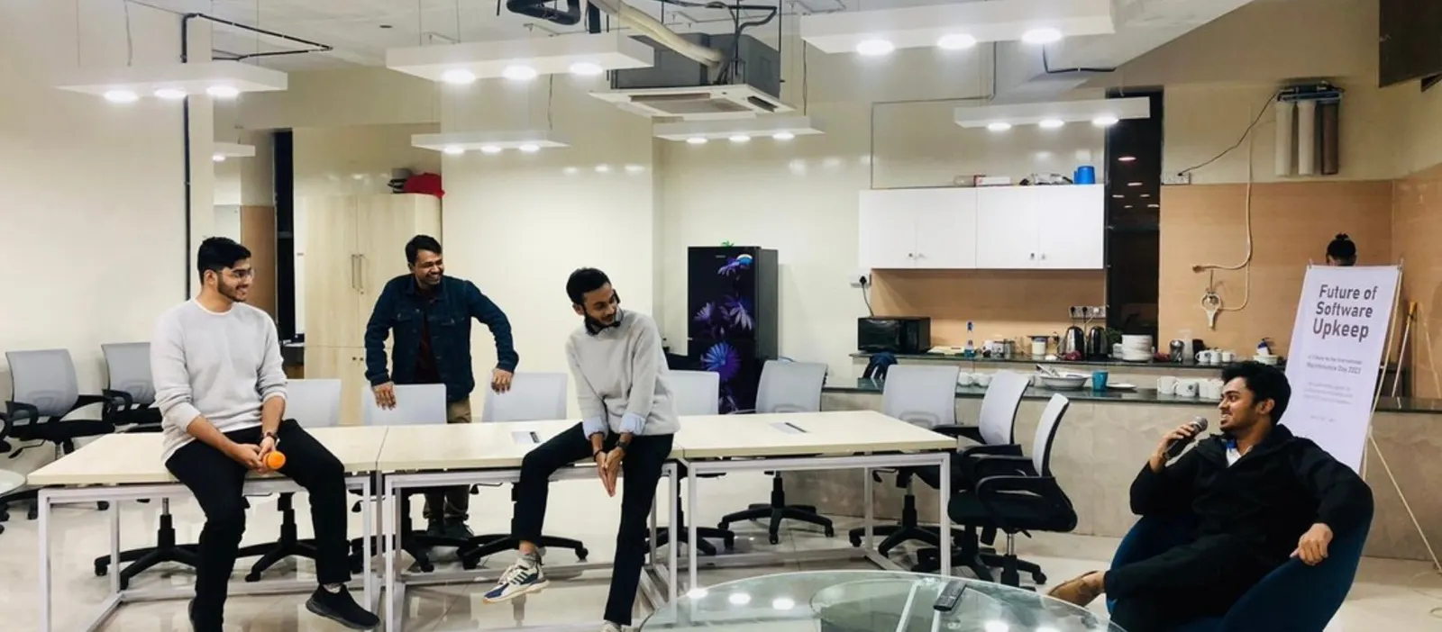A Devs Core session titled Future of Software Upkeep in an open-plan office